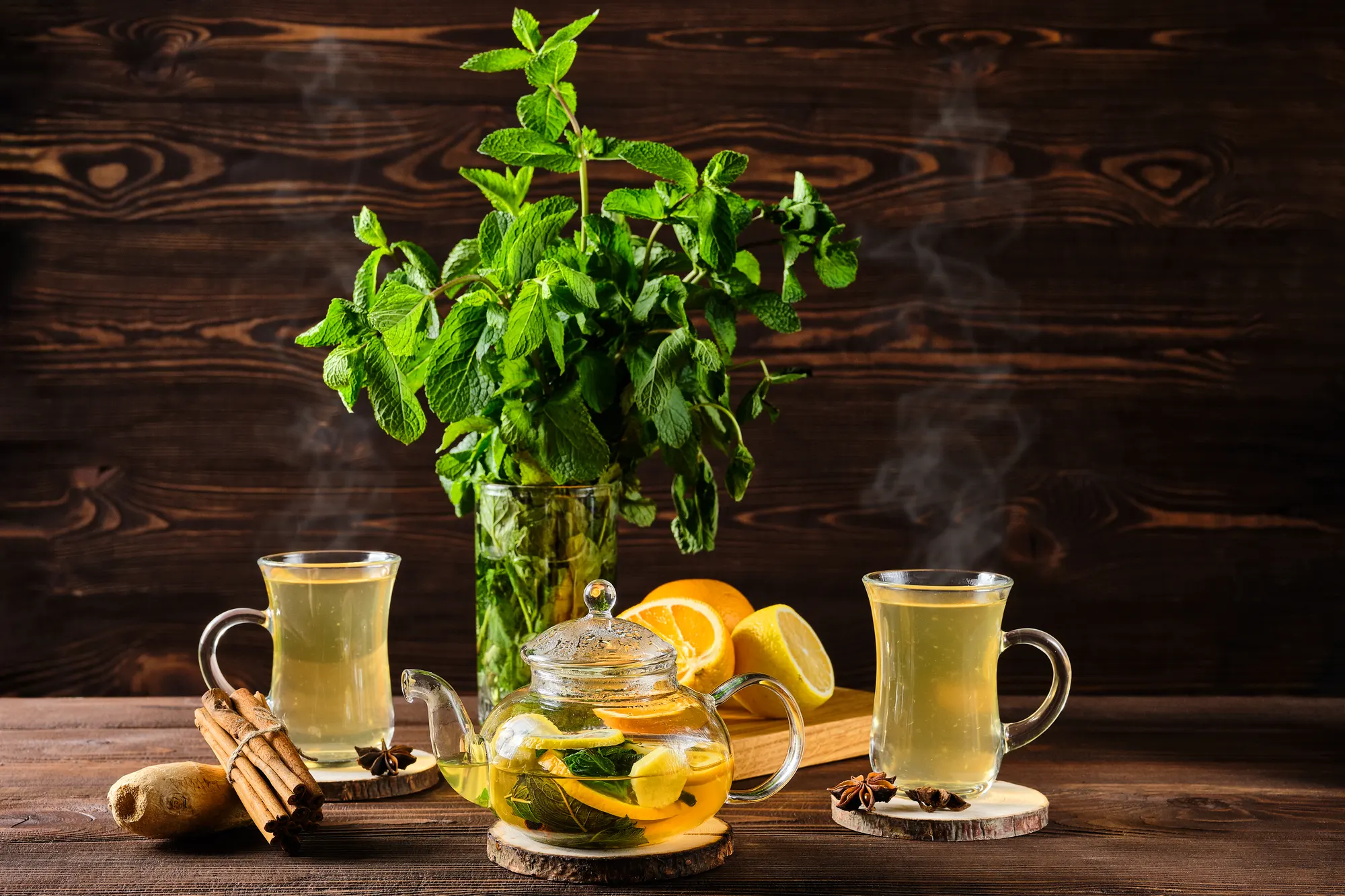 Hot herbal tea with lemon and fresh mint in glass cups