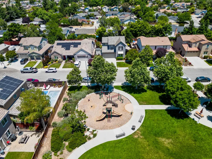 Aerial view of a suburban neighborhood with a park and playground