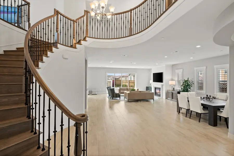 Curved grand staircase and open floor plan in a new home